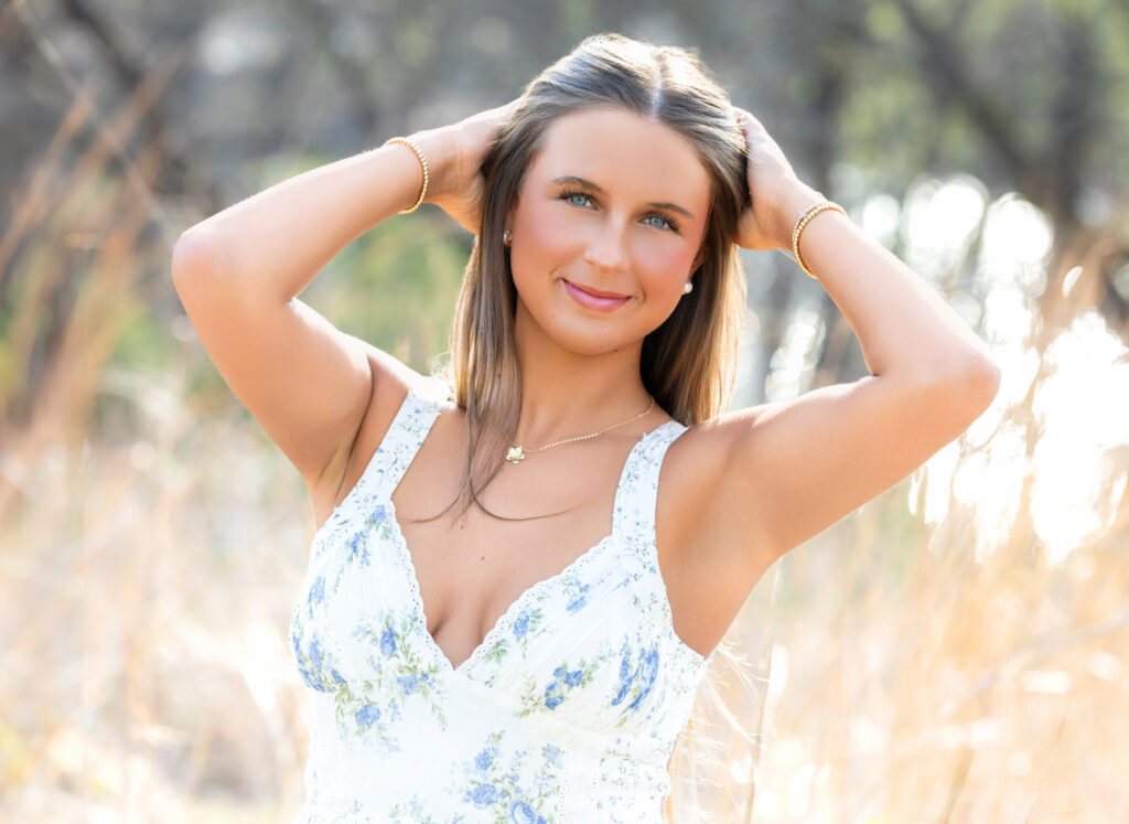 high school senior with hands in her hair