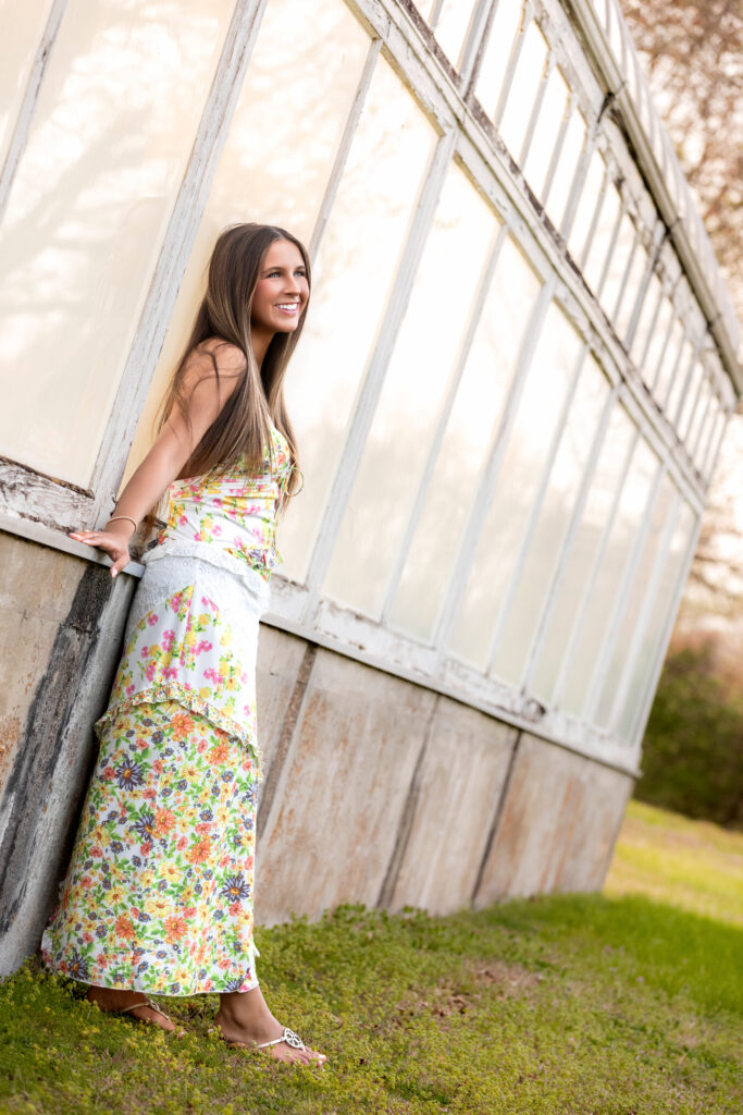 high school senior next to a glass building