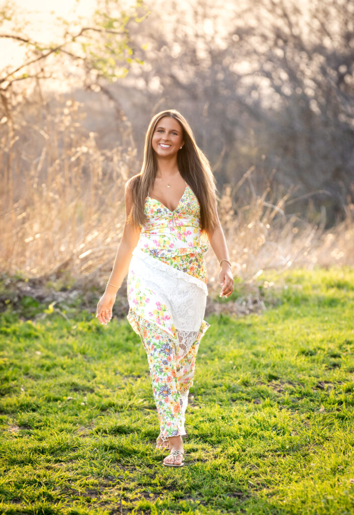 high school senior walking in a field