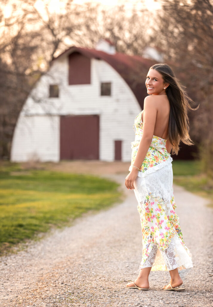 high school senior in front of a barn