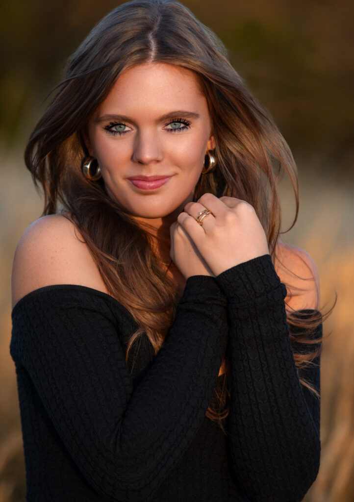 senior portrait in a field during golden hour close up