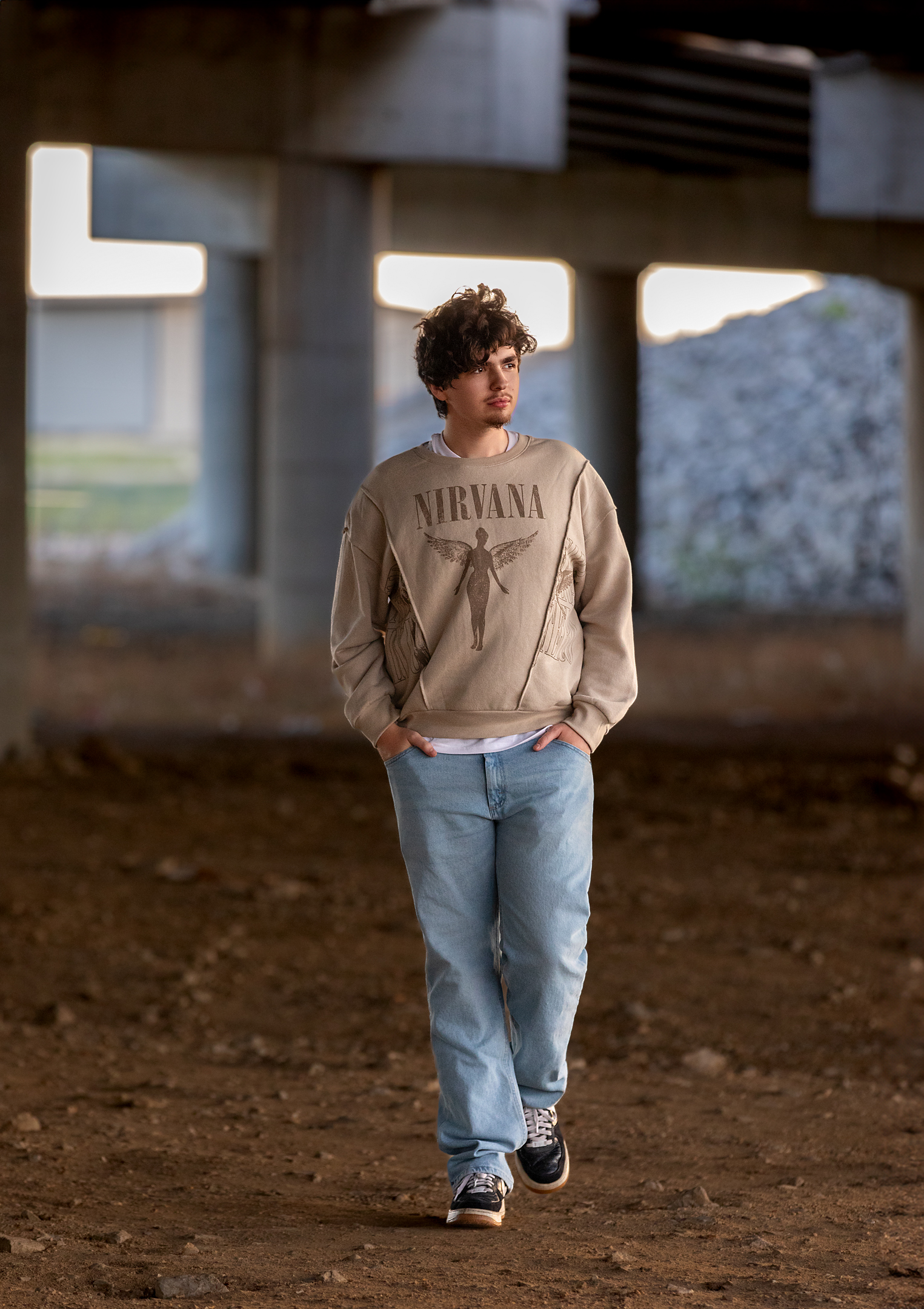 High school senior under a bridge in nirvana shirt