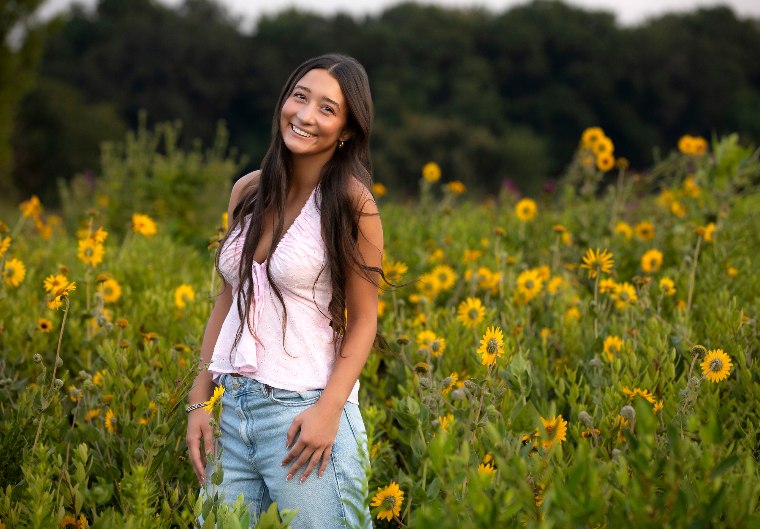 high school senior portrait in field of flowers