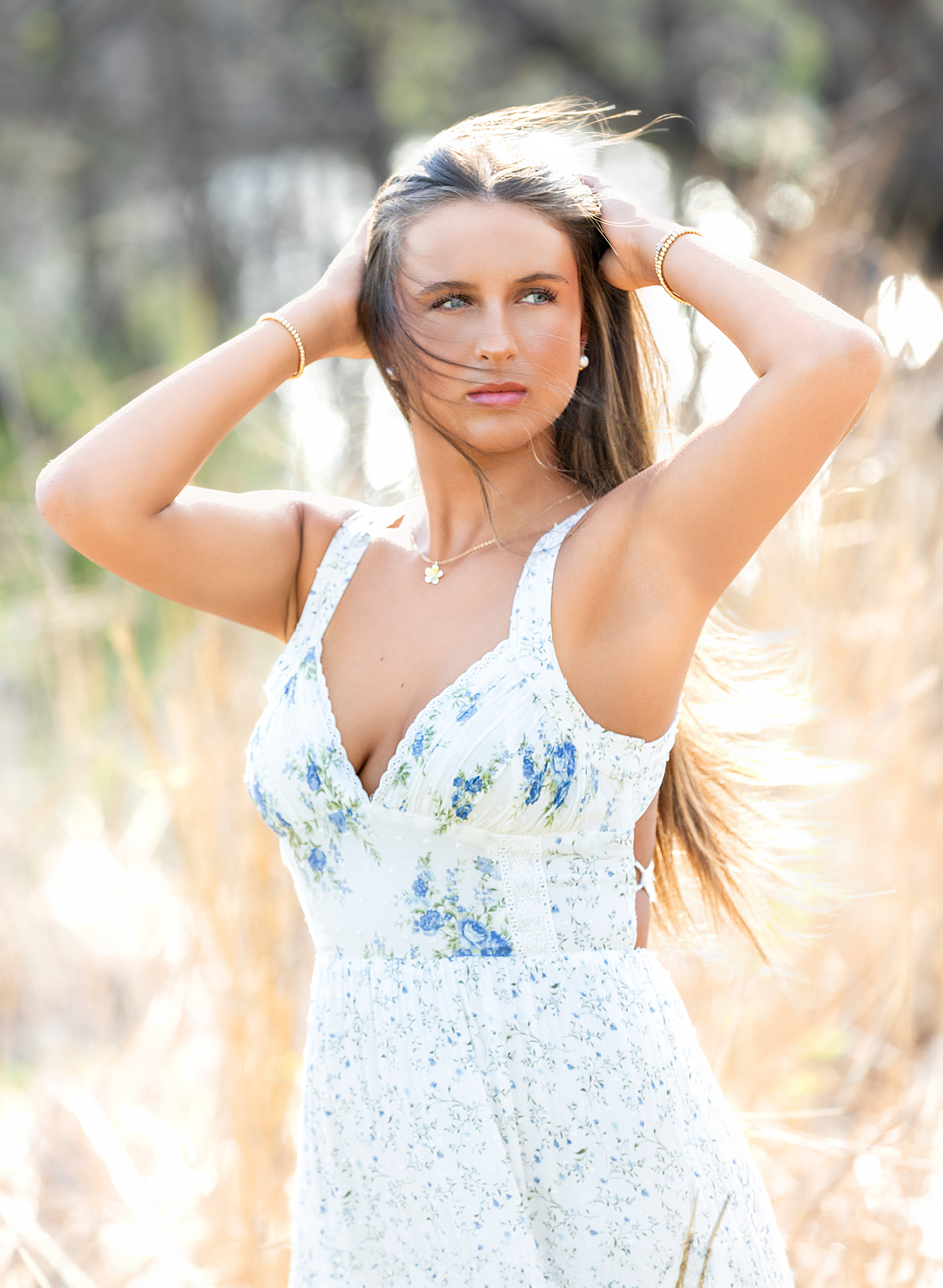 high school senior in a field looking away
