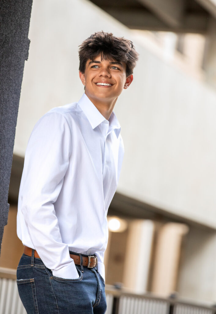 High school senior in white oxford and jeans hands in pockets