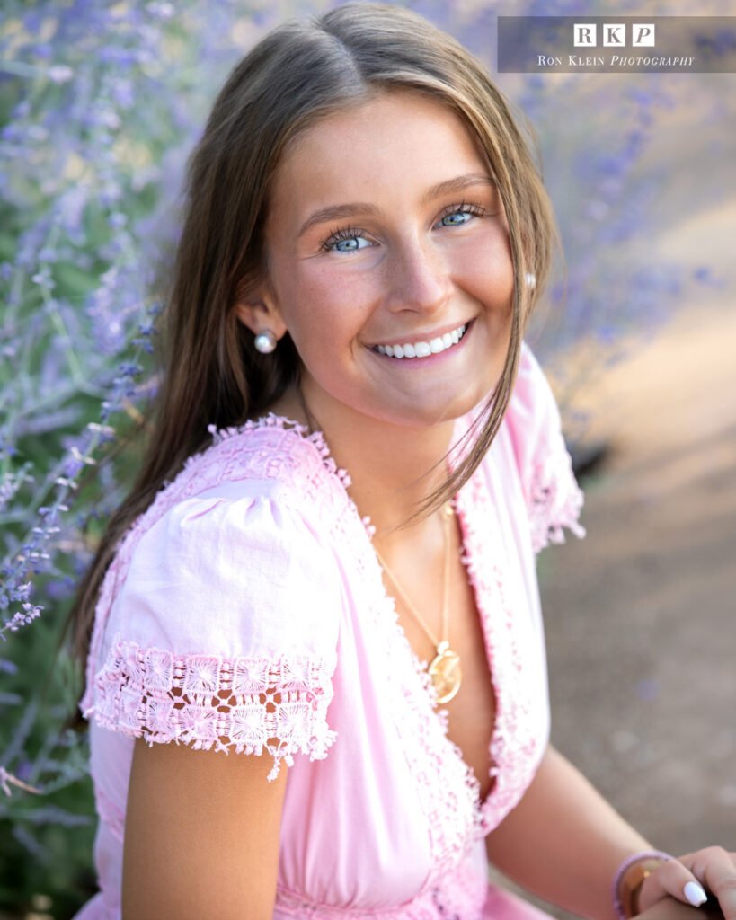 High school senior close up brown hair blue eyes pink dress