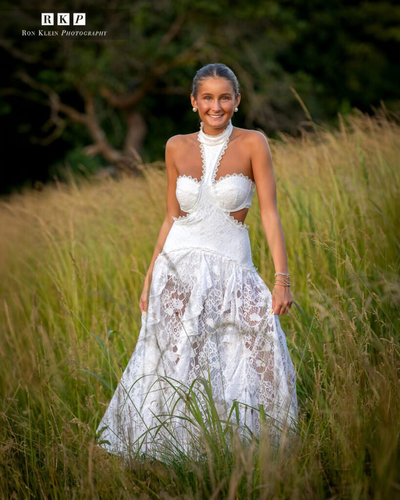 High school senior golden hour white dress in grassy field