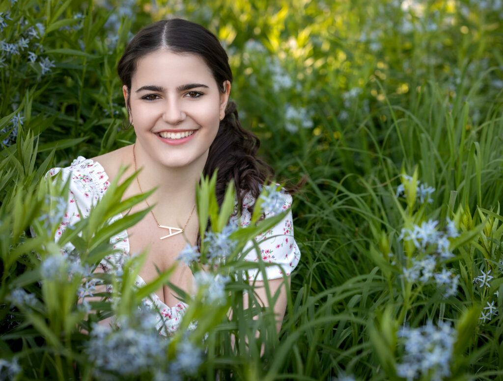 High School Senior Spring Session. Sitting in a field of blue flowers