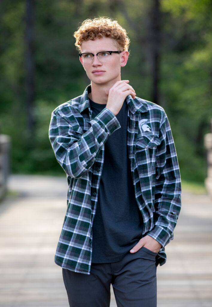 High school senior summer session red curly hair walking in Wildwood Park