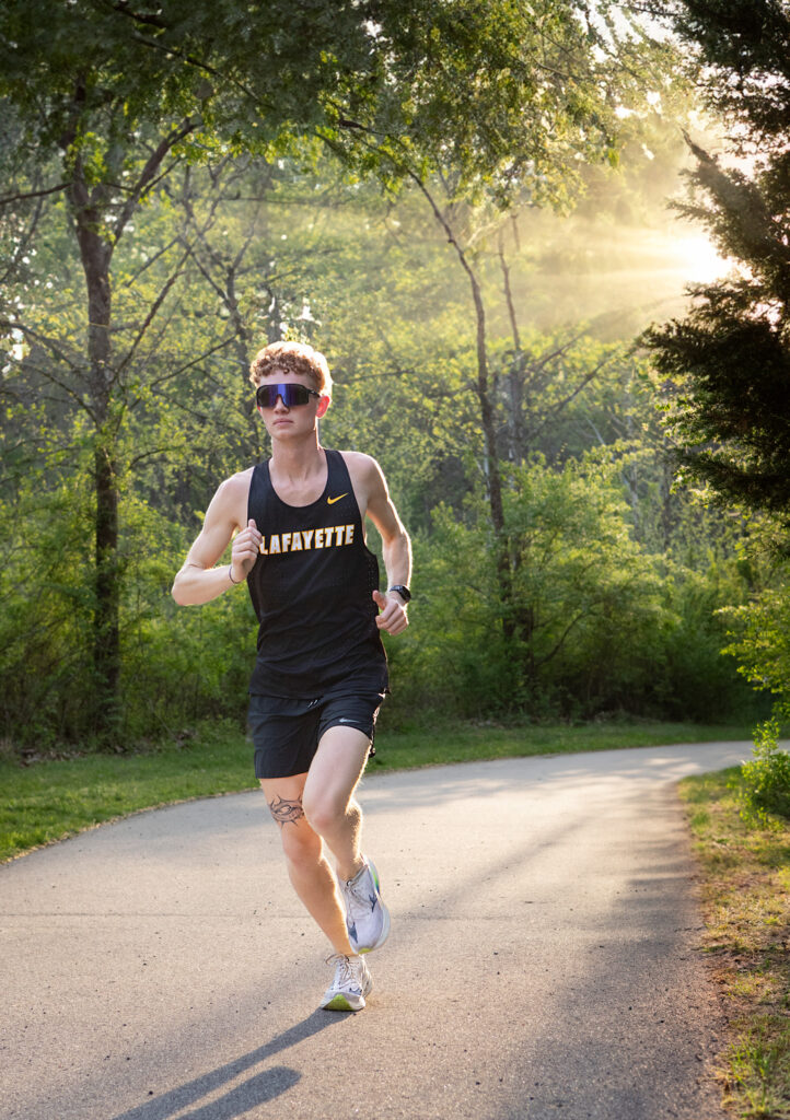 High school senior running at sunset at Wildwood Park on the trail