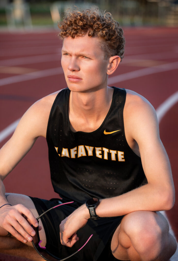 High school senior squating on the track at Lafayette High School